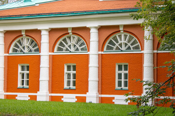 Fototapeta premium Red brick wall with white arched windows