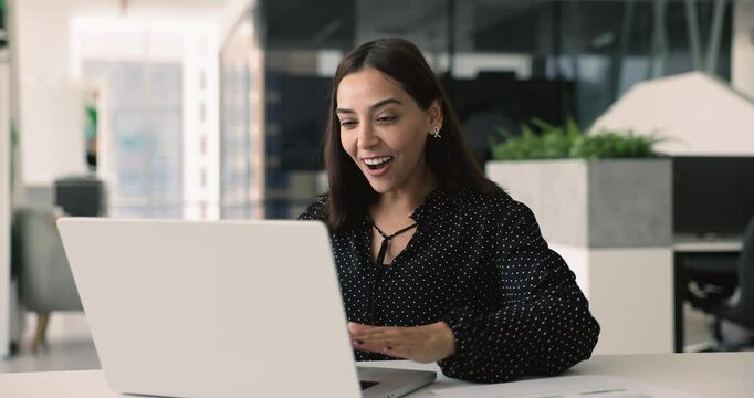 Businesswoman read e-mail with great news feel happy, exceeding revenue target, succeed professional goal, get promotion or monetary bonus, celebrate successful innovative product or service launch