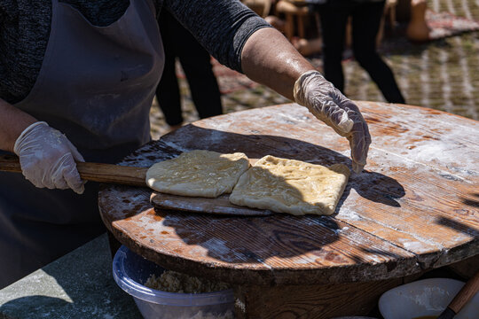 Traditional Georgian street food preparation of khachapuri and tonis puri