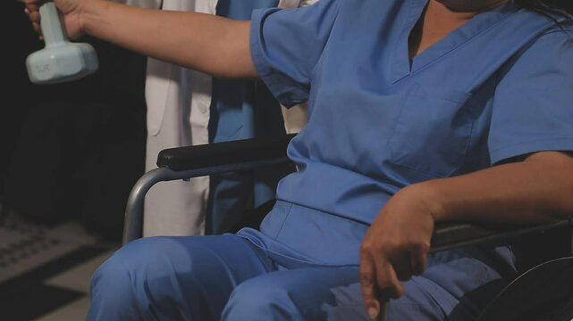 doctor is checking for muscle injuries and using dumbbells test injury and also help with physical therapy strengthen muscles because physical therapy will help strengthen muscles and help blood flow