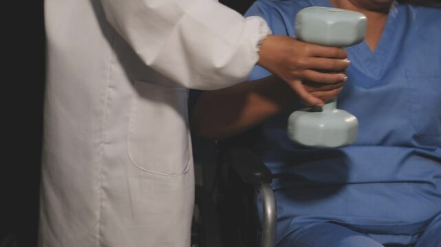 doctor is checking for muscle injuries and using dumbbells test injury and also help with physical therapy strengthen muscles because physical therapy will help strengthen muscles and help blood flow