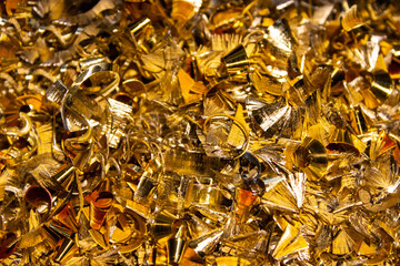 Shiny bright bronze shavings close-up. Metal waste from production.