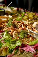 Vibrant salad spread with grilled chicken, fresh vegetables, and pickles at a festive gathering