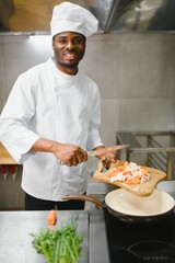 handsome african american chef at restaurant kitchen