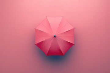 Bright pink umbrella on a pastel background in a minimalist stylistic arrangement