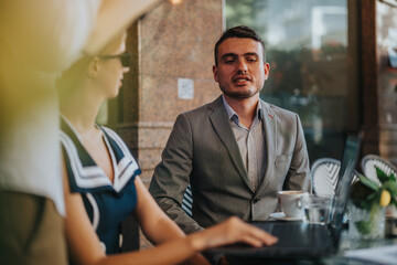 Businesspeople engaging in a productive conversation outdoors, illustrating teamwork and...