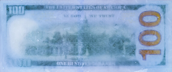 100 US dollar frozen under a layer of ice