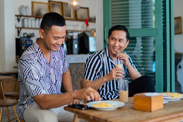 Two friends share a happy breakfast moment in a relaxed caf setting