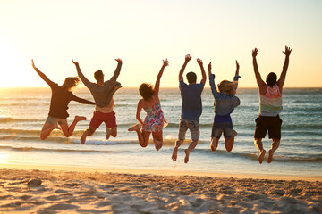 Fototapeta premium Back, beach and people with energy, jump and bonding together with journey, adventure and travel. Getaway trip, summer holiday and men with women, ocean and seaside with leap, Bali and waves with joy
