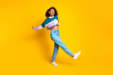 Full size photo of lovely young lady sunglass enjoy dancing dressed stylish striped garment isolated on yellow color background