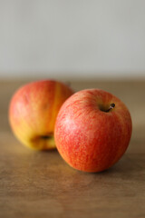 Ripe apples on a wooden table, shallow depth of field.