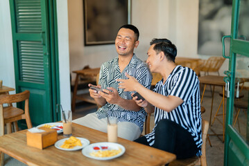 On a sunny morning, two friends enjoy breakfast and each others company at a cozy cafe