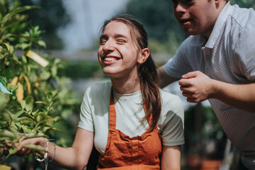 A young woman in a wheelchair and a man with Down syndrome enjoying a vibrant garden. They are...