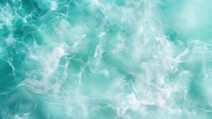 Obraz premium A close-up of the ocean surface with abstract white foam textures against a bluish-turquoise backdrop, capturing the essence of fluidity and movement.