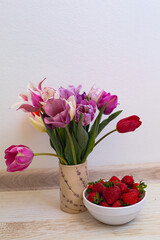 still life flowers in a vase and strawberries