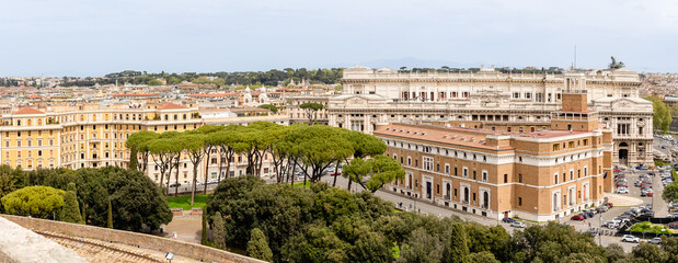 Obraz premium Rome, Italy - April 11, 2024: Rome, Italy - April 11, 2024: Rooftops and houses of the city of Rome, seen from the viewpoint of the Castel Santo Angelo in Rome, Italy