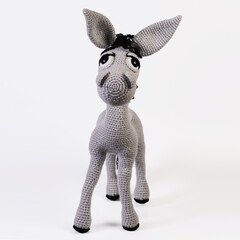 Amigurumi doll gray donkey stands background white isolated
