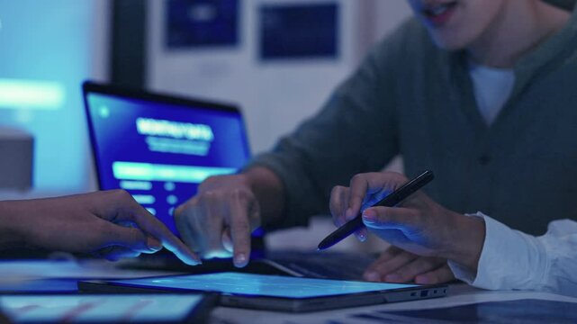 close up hand team of financial discussion fintech technology planning, analyzing digital financial data and strategy in a modern office at night