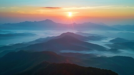 Obraz premium Sun Rising Over Misty Mountain Range