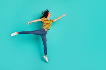 Full length photo of lovely young lady dance ballet graceful dressed stylish striped garment isolated on cyan color background © deagreez