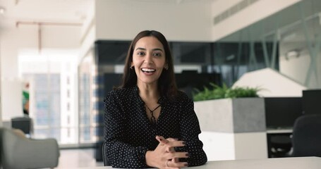 Arabic businesswoman greeting partner start virtual negotiations event seated in office, provide assistance, help, information to corporate client using video call and conference modern application