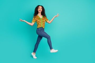 Obraz premium Full body photo of pretty young girl walking playful wear trendy striped outfit isolated on aquamarine color background