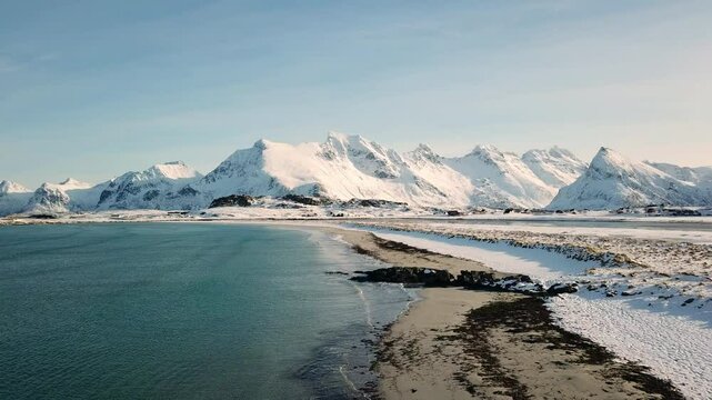 breathtaking white sandy beach near Fredvang, Lofoten, Norway, in winter, taken with a drone