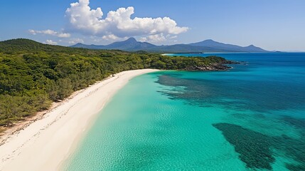 Obraz premium Aerial view of a tropical beach with turquoise water and white sand.