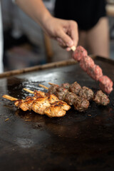 Grilled meat skewers in a herb marinade on a grill pan, top view, Fresh turkey meat skewers, Kabab, beef, street food