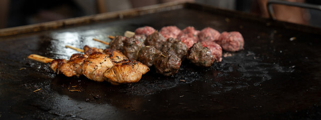 Grilled meat skewers in a herb marinade on a grill pan, top view, Fresh turkey meat skewers, Kabab, beef, street food