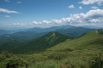 A breathtaking view of rolling hills and distant mountains under a bright blue sky
