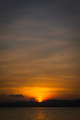 Golden sunset at sea. Portrait. Bonbon Beach, Romblon Island, Philippines