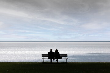 Intimate togetherness by the lake - a couple gazes into the distance across the water