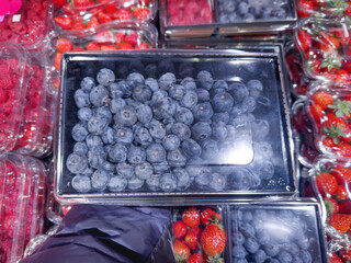 buying fruits and  berries ( raspberries, blueberries, strawberries, gooseberries)at the market