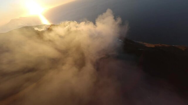 FPV Drone flight over erupting Stromboli volcano in Sicily during sunset