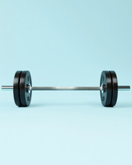 Barbell with Weights on Light Blue Background, Barbell loaded with black weight plates placed on a clean, light blue backdrop. Minimalist fitness and strength training concept.

