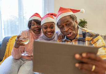 Family having fun video calling during christmas celebration - Powered by Adobe