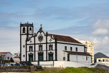 Sao Roque church in Sao Miguel island distant view against ocean waves Azores Portugal