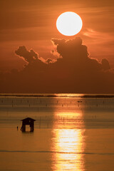 colorful sea waving againts sky at sunrise timing.