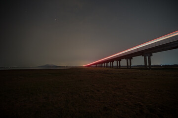 Train is moving on rail at night time with  background of star location at thailand
