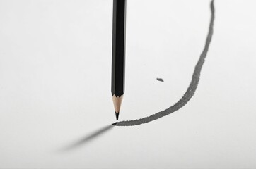 Close-up of pencil poised above paper evoking creativity