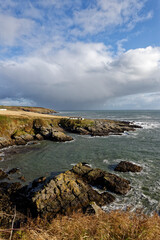 Portlethen Bay near to Stonehaven looking north with the Old Salmon Fishing Station on the headland with the small harbour below.