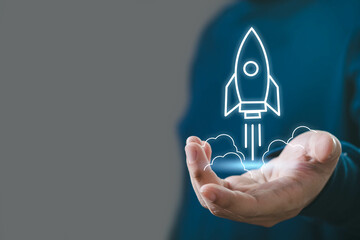 A person holds a glowing rocket icon in their hand, symbolizing innovation, technology, and launching new ideas.
