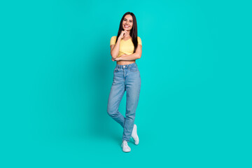 Full body portrait of pretty young woman think wear top isolated on turquoise color background