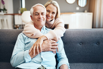 Hug, smile and portrait of mature couple on sofa with love, healthy relationship and loyalty to partner in home. Face, senior man and woman embrace together for trust, support and holding hands in UK