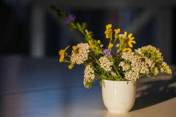 Meadow flowers on a table in the sunny morning light