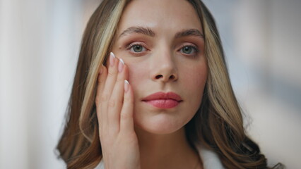 Portrait beauty lady looking camera in bathroom. Happy calm woman examining skin