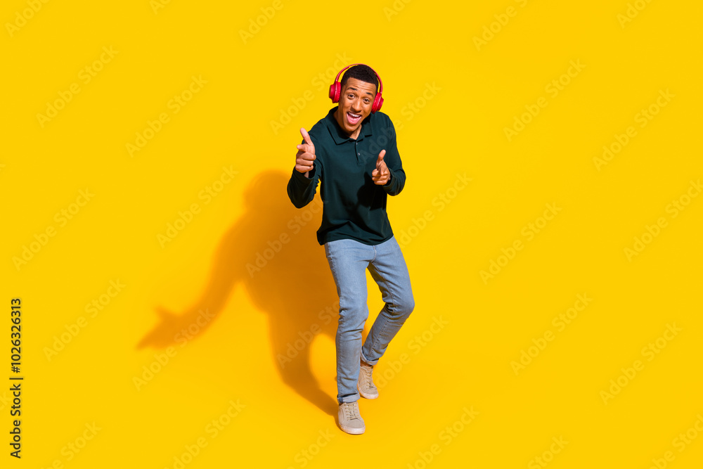 Sticker Full size photo of handsome young guy headphones dance point you dressed stylish green garment isolated on yellow color background