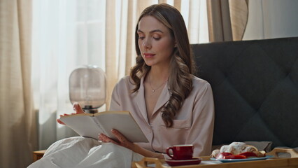 Home girl enjoying book on weekend closeup. Woman holding literature in bed