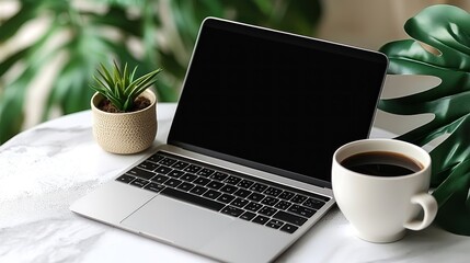 A laptop is open on a table with a cup of coffee next to it